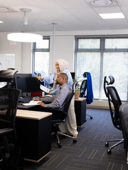 Diverse female and male businesspeople working in office with open space. Business, corporation, cooperation and working in office concept.